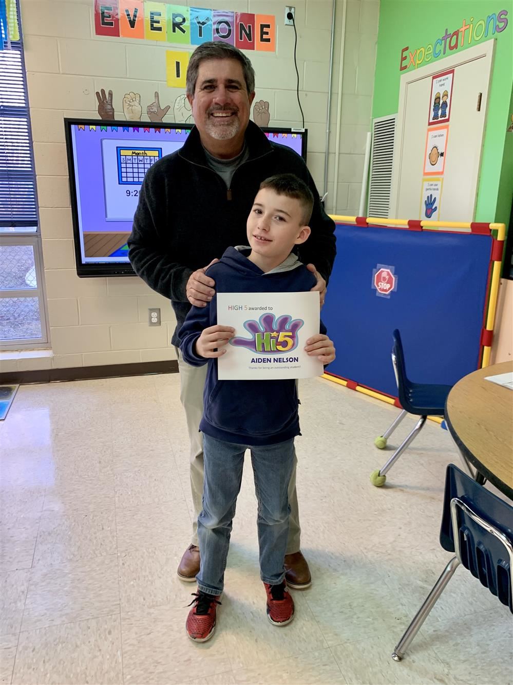 student and Mr. Stewart pose together